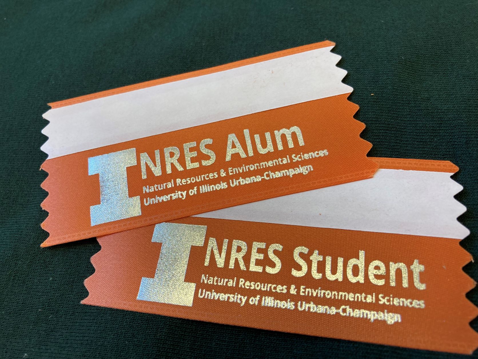 Image of name tag ribbons say NRES Alum or NRES Student