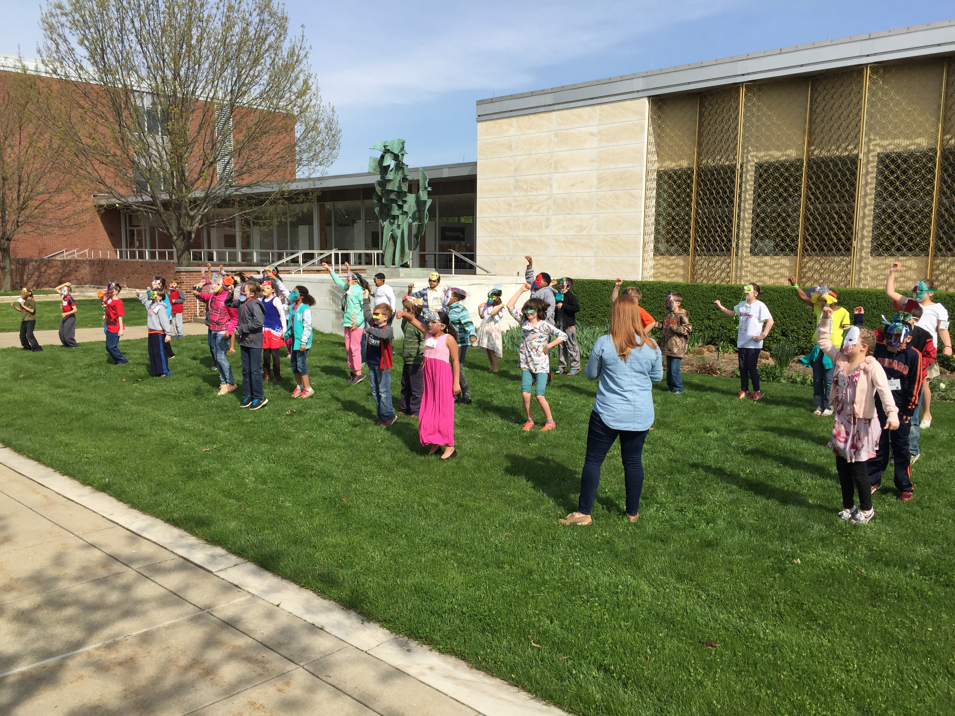 KAM-WAM students from Robeson and Thomas Paine Elementary schools sing "Everything Is Awesome!" from the LEGO' Movie on the lawn in front of Krannert Art Museum