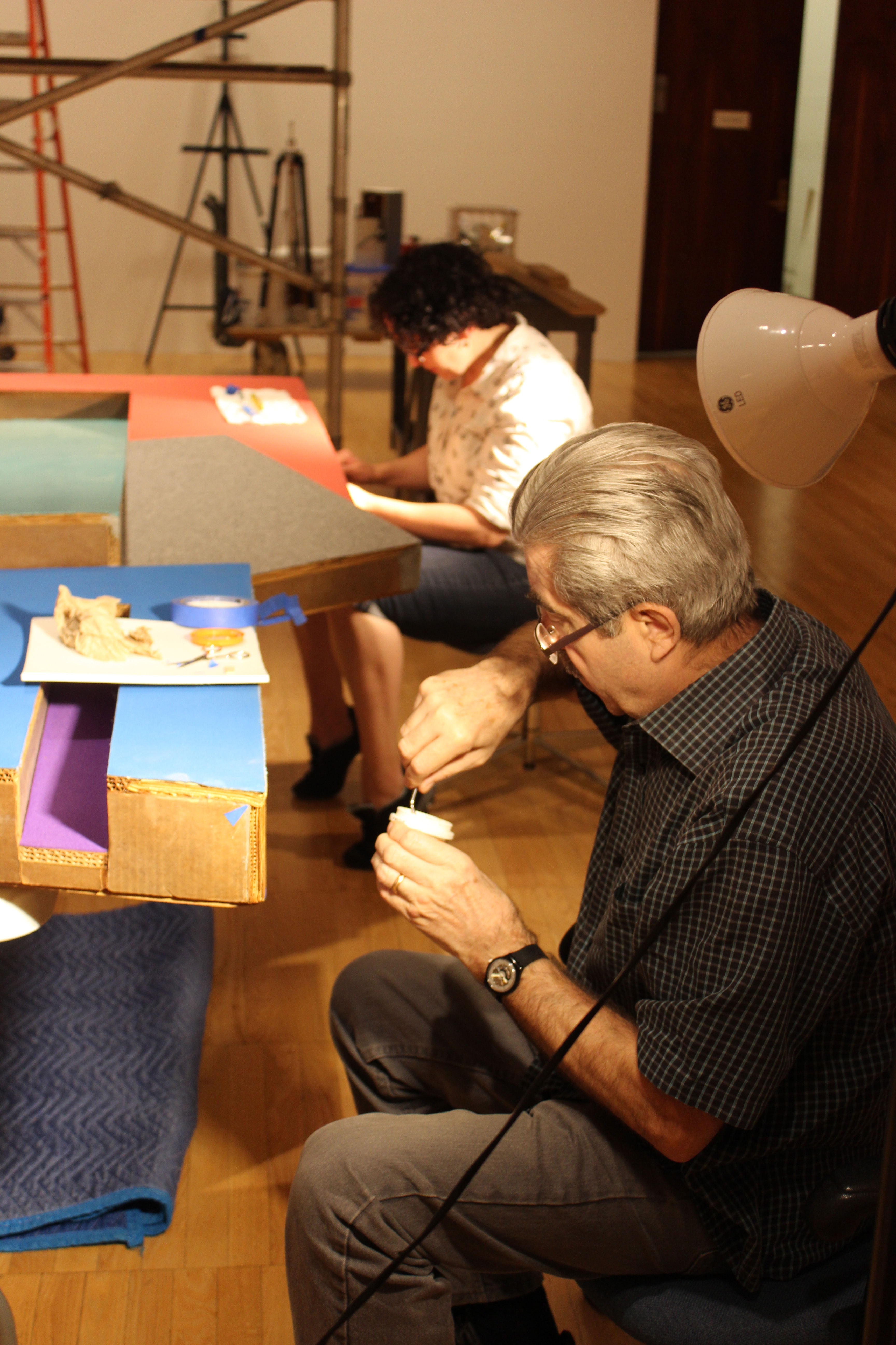 Luca Bonetti and Beth Nunan work to conserve Frank Stella's "Kosangrodek III" in the East Gallery at Krannert Art Museum (June 2015)