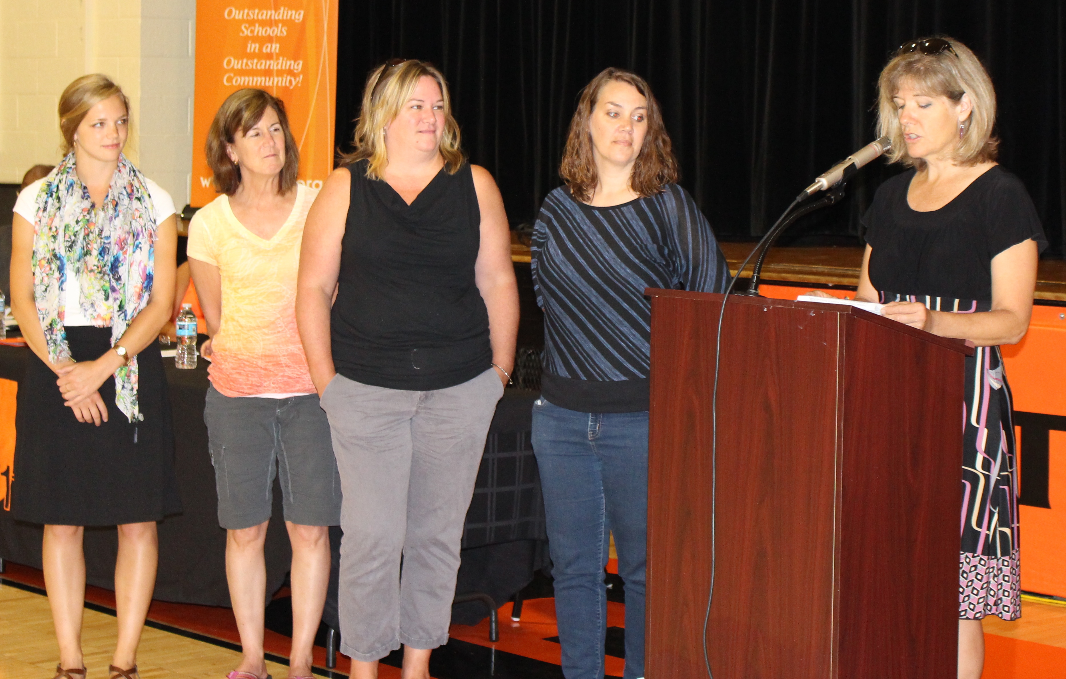 Carol Lynn Comparetto (Central HS), Jill Lagerstam (Urbana HS), Shannon Percoco (Centennial HS) and Susan Gleason (Urbana HS) are acknoledged by CUSF Executive Director Molly Delaney during the opening day ceremony at Urbana Middle School, Urbana, Ill.