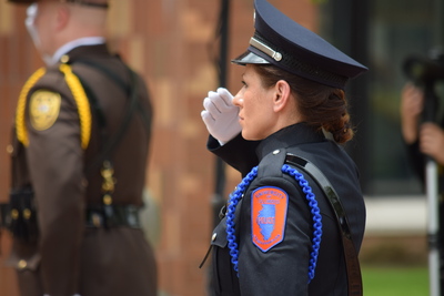 Female officer saluting.