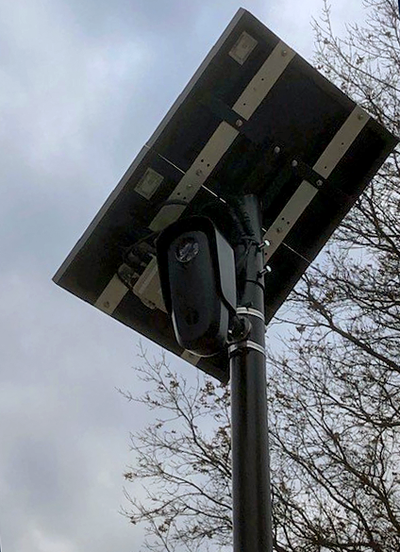 Image of a license plate reader against a cloudy sky