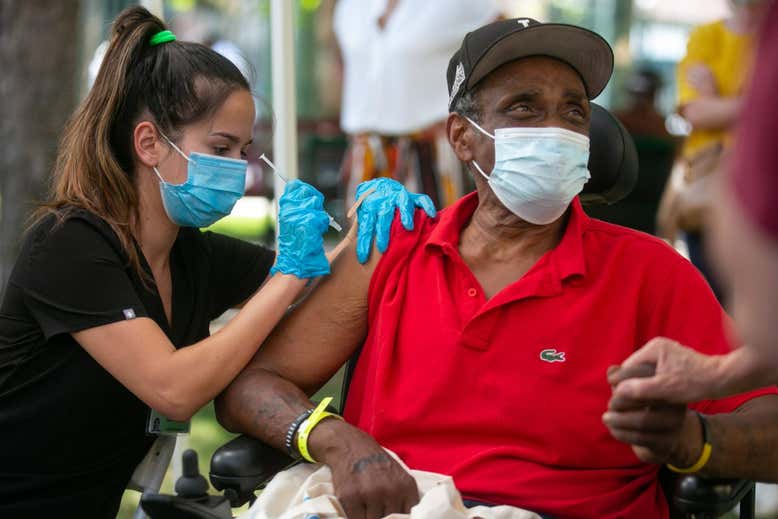 A man getting vaccinated in LA  Jason Armond / Los Angeles Times via Getty Images