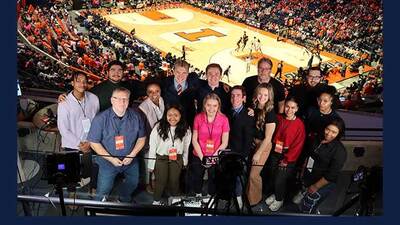 The on-air and production team for 'Illini Sports Night' in a group pose during an Illini Women's Basketball game