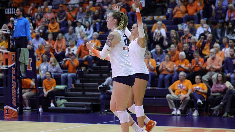Illinois volleyball players celebrate a point against Rutgers on their home court