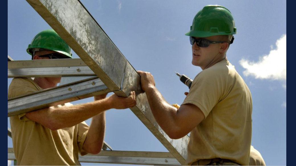 construction workers building structural framing. Image via Creative Commons