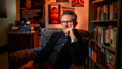 English professor Jim Hansen in his office, surrounded by horror movie posters. Photo by Fred Zwicky