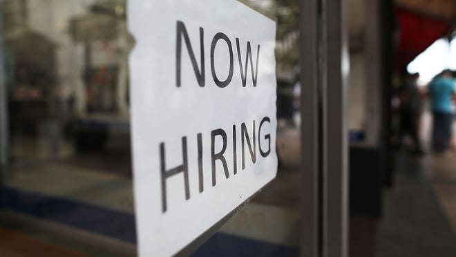 'now hiring' sign via Getty Images