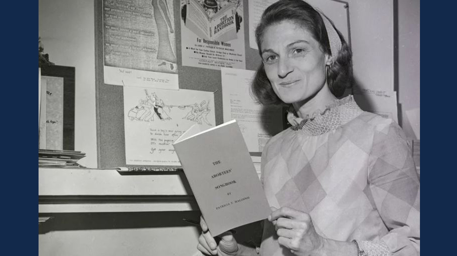 Patricia Maginnis holds her Abortees' Songbook and stands next to a bulletin board full of abortion information. The early abortion rights advocate, pictured here in 1970, died earlier this year. Bettmann/Bettmann Archive