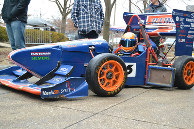 orange and blue race car designed by Illinois Engineering students
