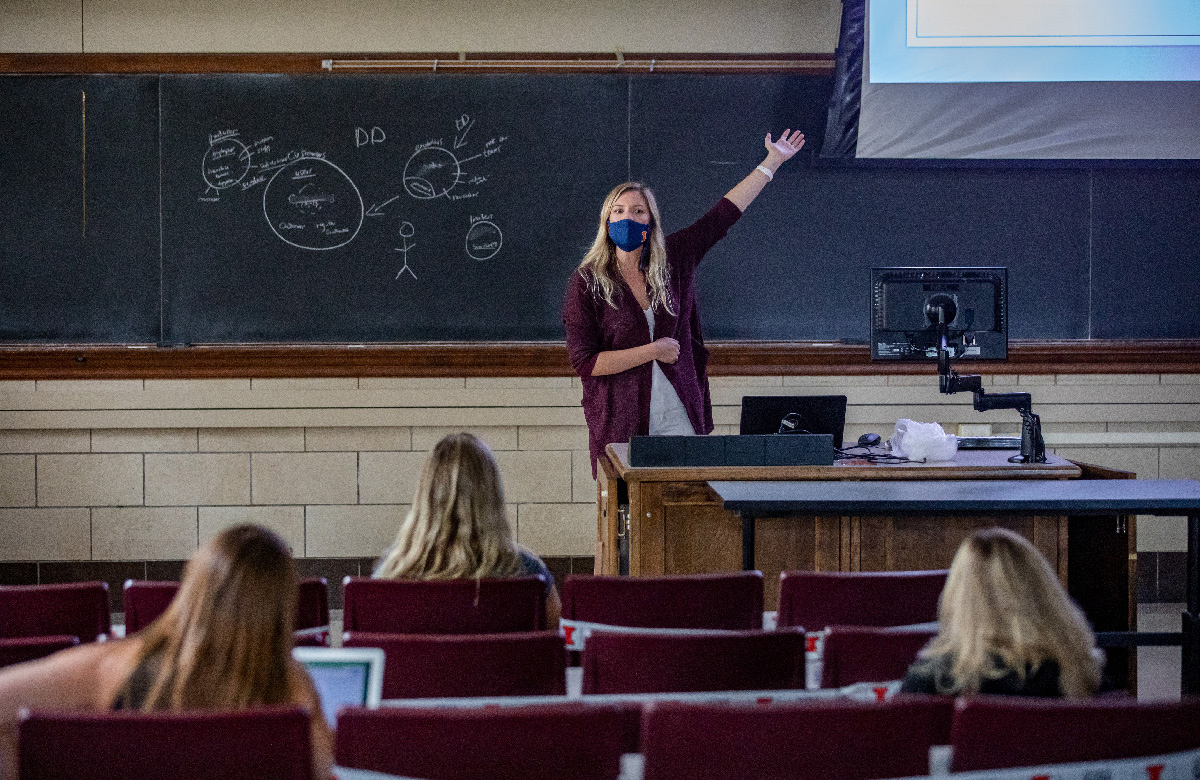Professor Allison Vance teaches in a mask and with students dispersed to safe distances. Photo by Fred