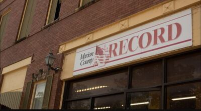 exterior signage at the office of the Marion County Record newspaper. Photo by Kansas Reflector/Sam Bailey.