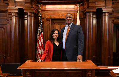 Dean James Anderson poses with State Senator and UI alumna Cristina Pacione-Zayas in the Capitol Building