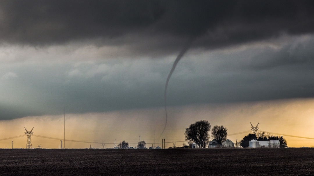 Tornado passing a farm house. Looking west from Illiopolis exit off I-72. (Source: Skip Talbot/National Weather Service)