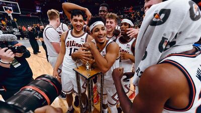 Alfonso Plummer hugs trophy as team poses after their win