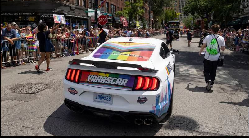 A decorated Ford Mustang NASCAR-sponsored car drives in the 52nd annual Chicago Pride Parade on June 25, 2023. (Brian Cassella/Chicago Tribune)