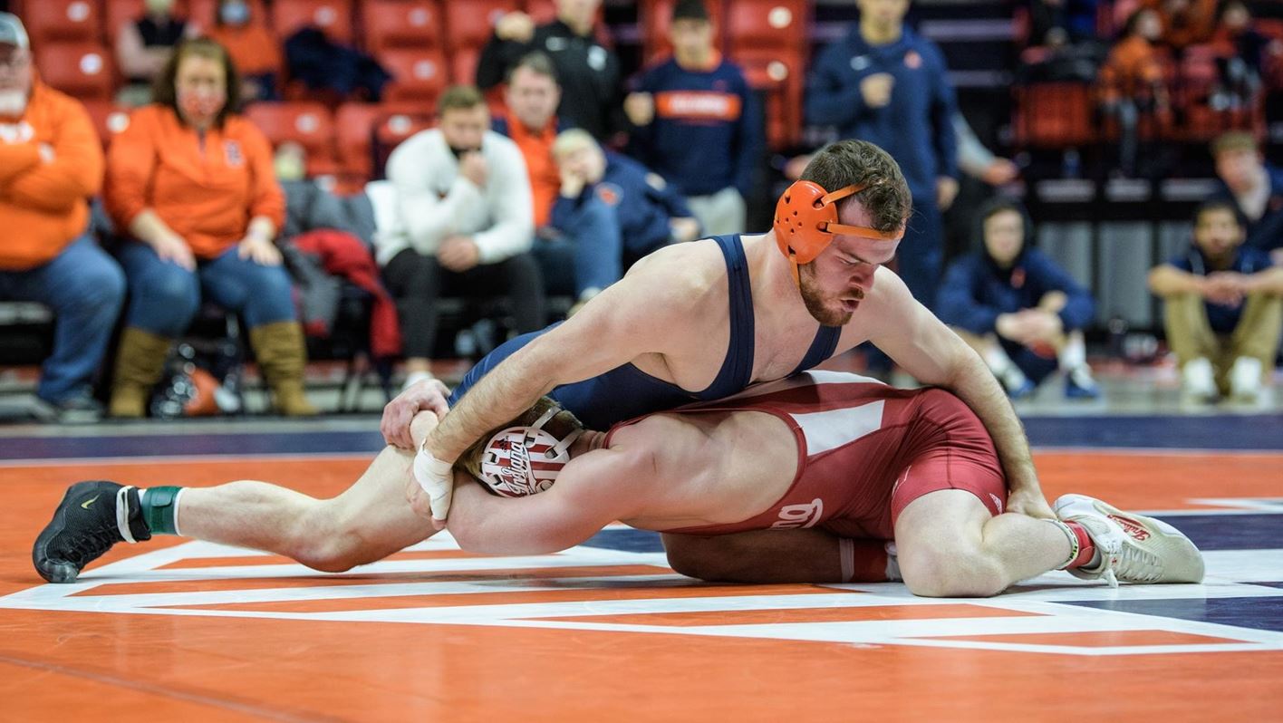 Illini wrestler Danny Braunagel grapples with an Indiana athlete