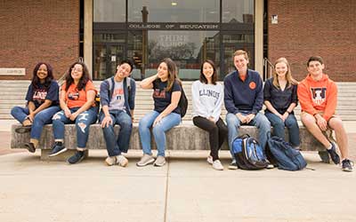 a group of U of I students sits on the steps outside the Education building