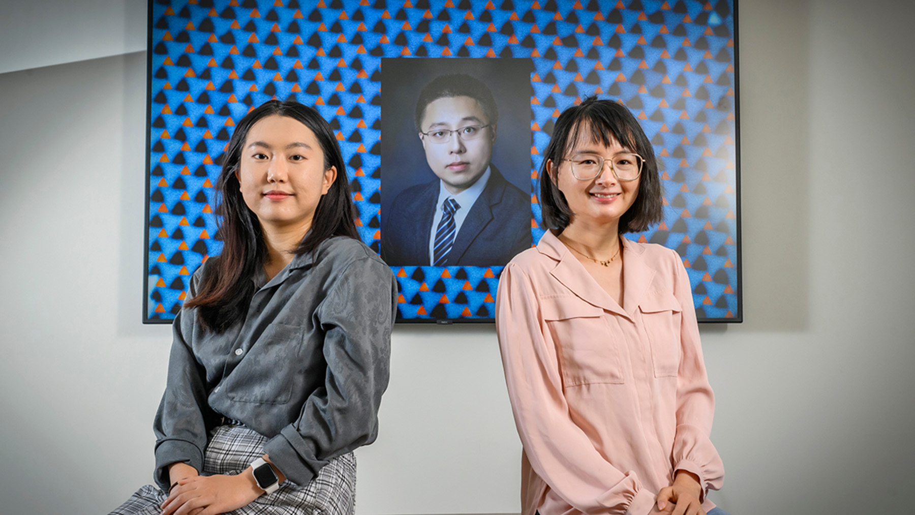 Jiahui Li, left, Shan Zhou and professor Qian Chen show off an electron micrograph image of their new pinwheel lattice structure developed to help engineers build new materials with unique optical, magnetic, electronic and catalytic properties.
