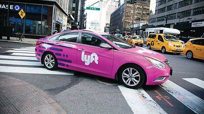 A pink Lyft, Inc., car drives in Los Angeles. Photo via Wikimedia Commons