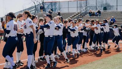 Illini Softball players go through a 'high-five' line following a recent victory