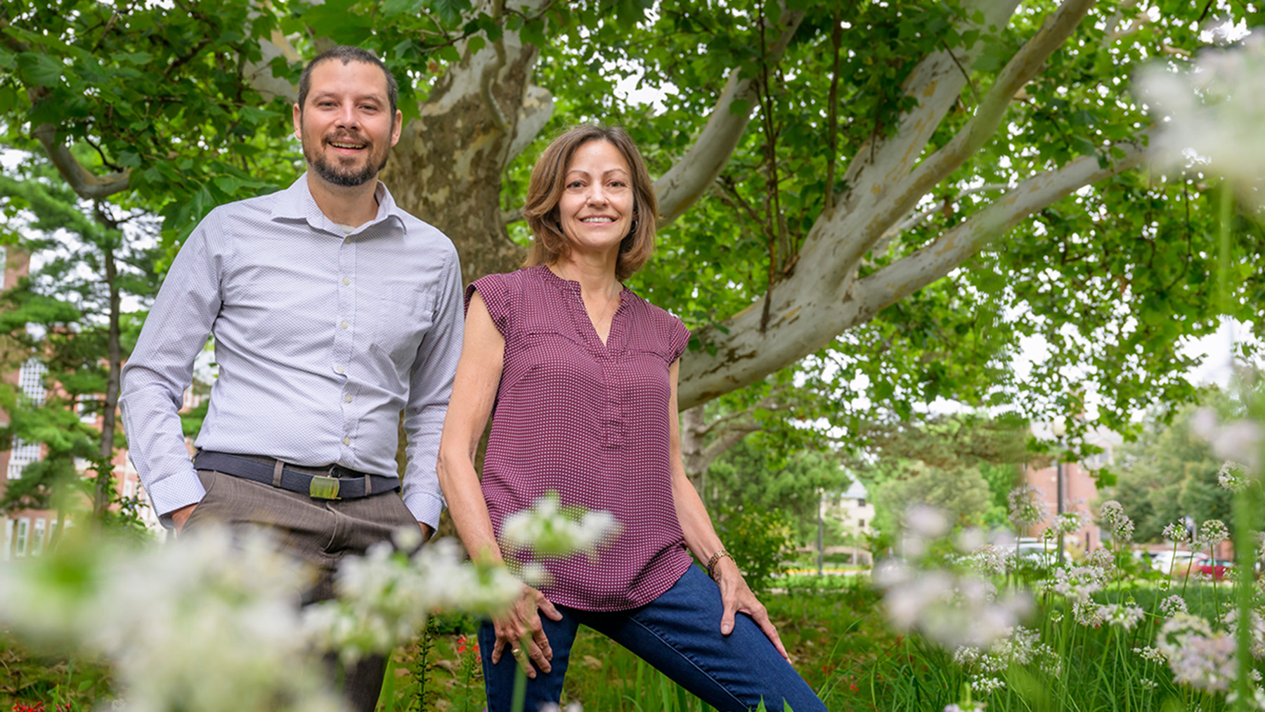 Eric Larson and Sally McConkey are standing in the U. of I.’s Red Oak Rain Garden, which has won conservation awards for its incorporation of water runoff features into a functional landscape.     Photo by Fred Zwicky