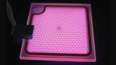 Photograph of a microplasma lamp peaking at 222-nm ultraviolet light for disinfection applications. The weak purple–red glow is due to an impurity in the lamp.