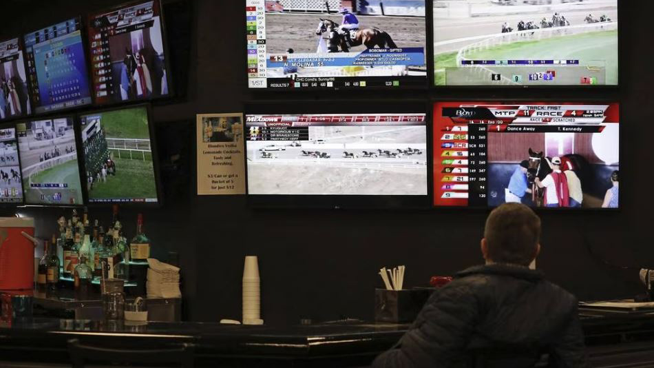 Horse races are displayed on screens at Club Hawthorne and PointsBet Sportsbook Thursday, March 3, 2022, in Crestwood. Illinois is permanently eliminating the in-person registration requirement for sports betting on March 5. (John J. Kim / Chicago Tribune)