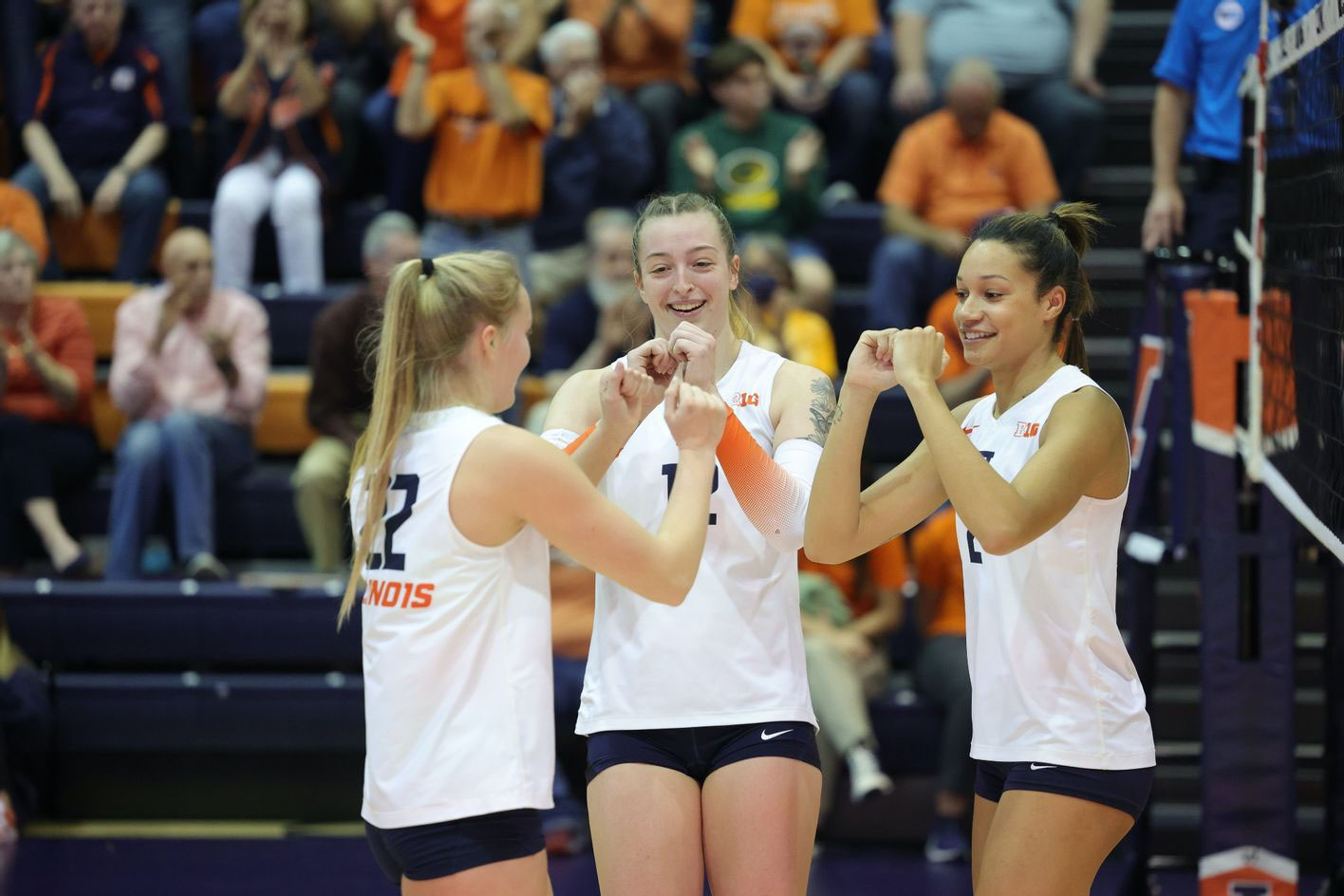 on-court photo of Illini Volleyball players Raina Terry, Brooke Mosher, and Rylee Hinton