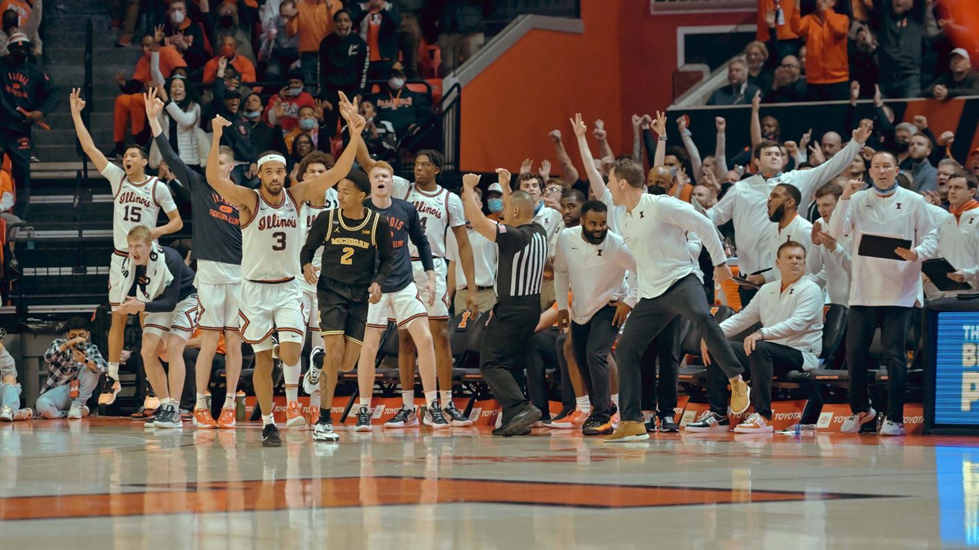 The Illini bench leaps in celebration late in Friday night's game against Michigan