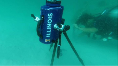 Diver sets up a camera that will track the sun from the ocean floor.