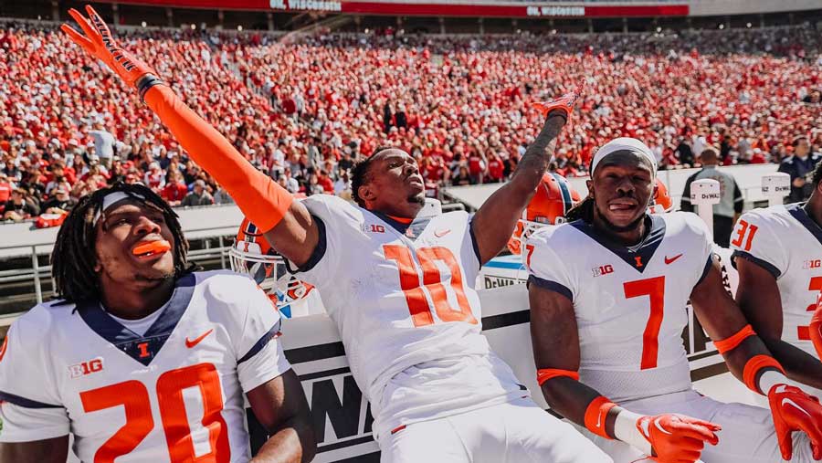 happy Illini football players along the sidelines in Madison