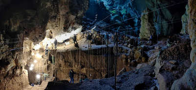 Interior of cave showing workers and scaffolding. The team excavated through layers of sediments and bones that gradually washed into the cave and were left untouched for tens of thousands of years.  Photo by Fabrice Demeter