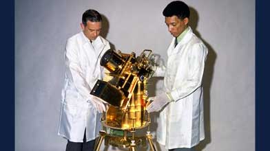 Dr. George R. Carruthers (right) and his colleague William Conway examine the Lunar Surface Ultraviolet Camera designed by Carruthers for the Apollo 16 lunar mission. Photo Credit: U.S. Naval Research Laboratory