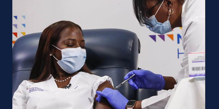 African American nurse gets a COVID-19 vaccine. Photo by Shannon Stapleton/Getty Images