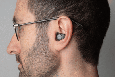 sideview of a man wearing a hearing device in his ear