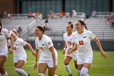 Smiling Illini Soccer players run off the field