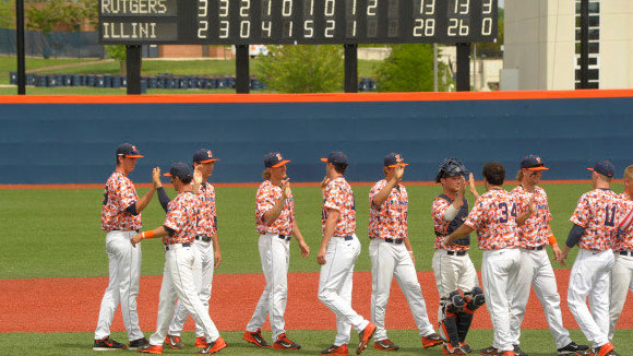 Illini baseball players high five each other after win