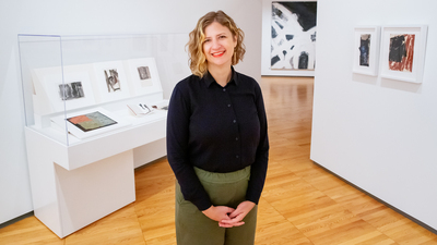 Amy L. Powell, the curator of modern and contemporary art at Krannert Art Museum, worked closely with Louise Fishman and her spouse, Ingrid Nyeboe, in organizing the exhibition. Fishman’s large-scale painting 'Blonde Ambition' is visible in the background. Photo by Brian Stauffer