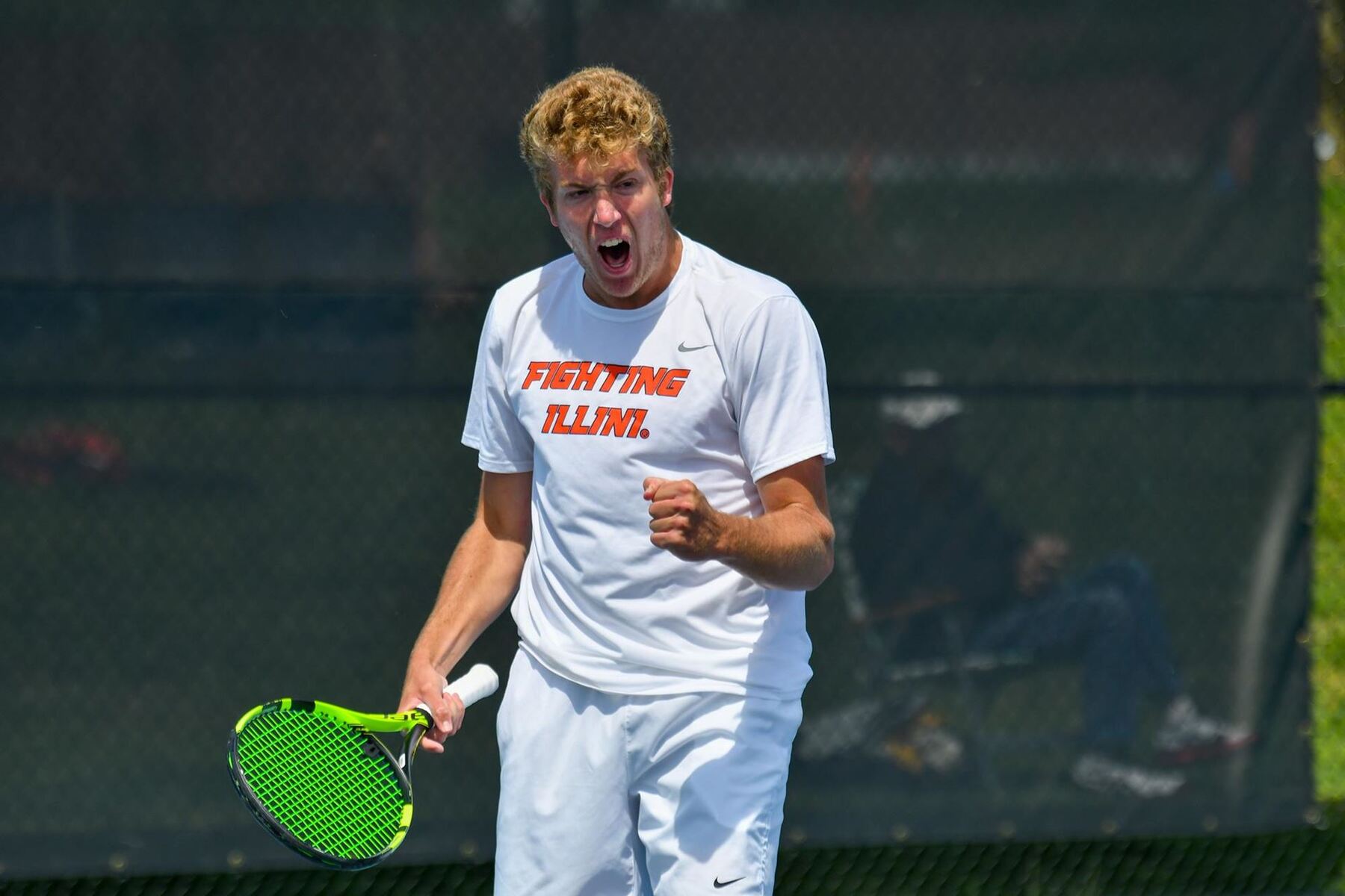 a tennis player reacts to winning a volley