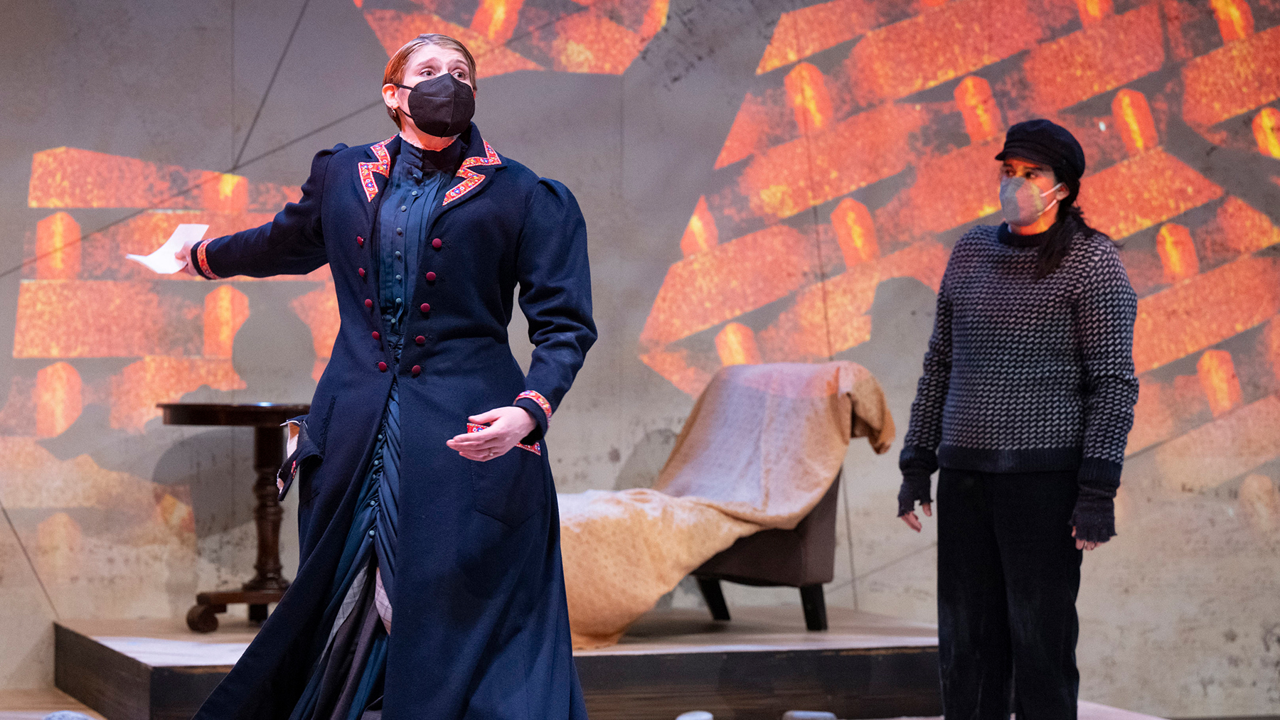 Sophia Pucillo plays Petra, the doctor’s daughter, with Raiya Wen (seated) as Hovstad, the editor of the town newspaper, “The People’s Messenger.”   Photo by Darrell Hoemann