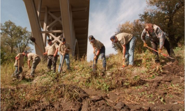 Members of an AmeriCorps conservation program dig trenches to stabilize the banks of the Minnesota River under the Fort Snelling-Mendota Bridge.Photograph by Darlene Pfister / Star Tribune / Getty