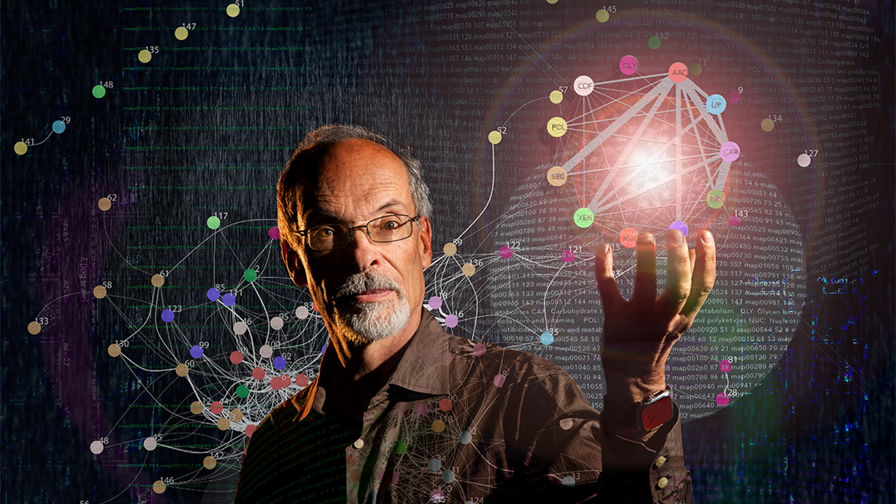 Gustavo Caetano-Anolles surrounded by depiction of molecular networks. Image by Fred Zwicky.