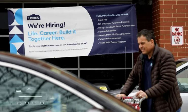 A hiring notice posted at a Lowe’s home improvement store in Northbrook. A state task force’s report said the pandemic showed the importance of “essential” workers in retail, health care and other sectors where wages and benefits can be low.Associated Press