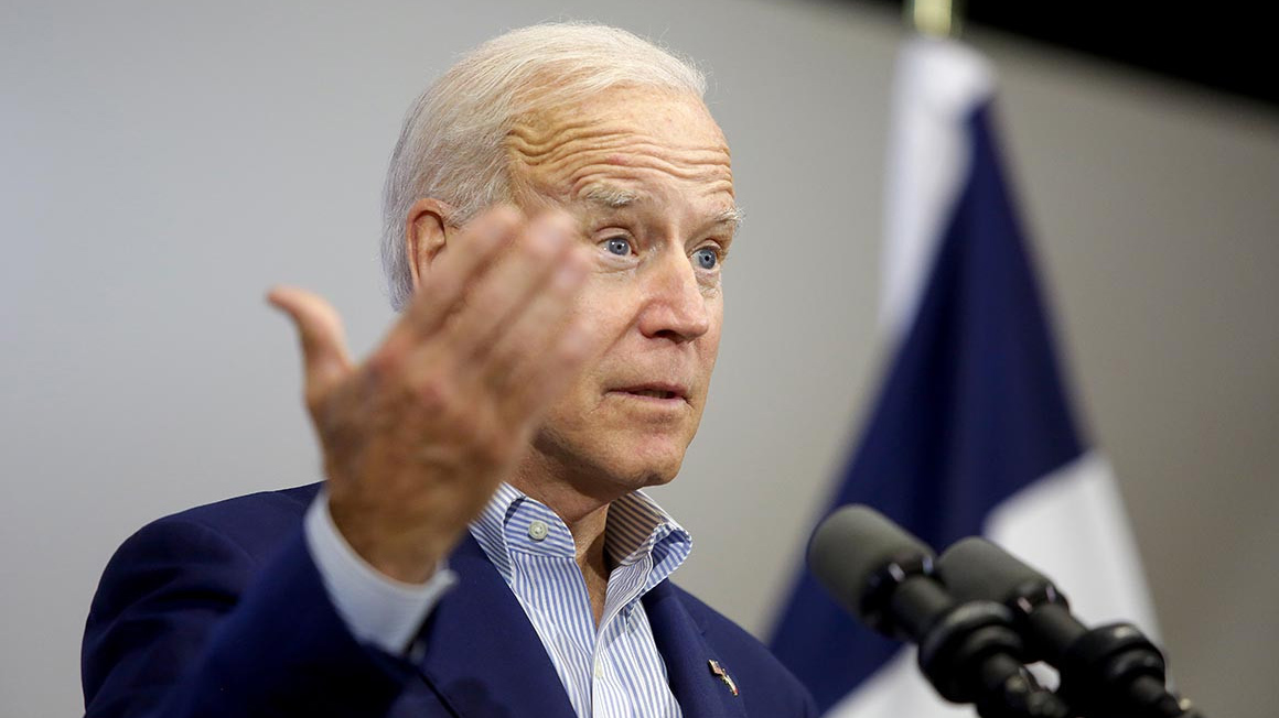 Democratic presidential nominee Joe Biden speaks at a podium. Joshua Lott/Getty Images