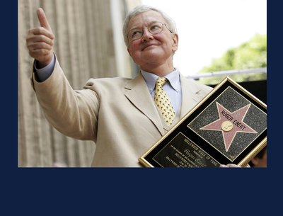 Roger Ebert poses with his star on the Hollywood Walk of Fame