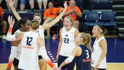 Illini volleyball players celebrate a point