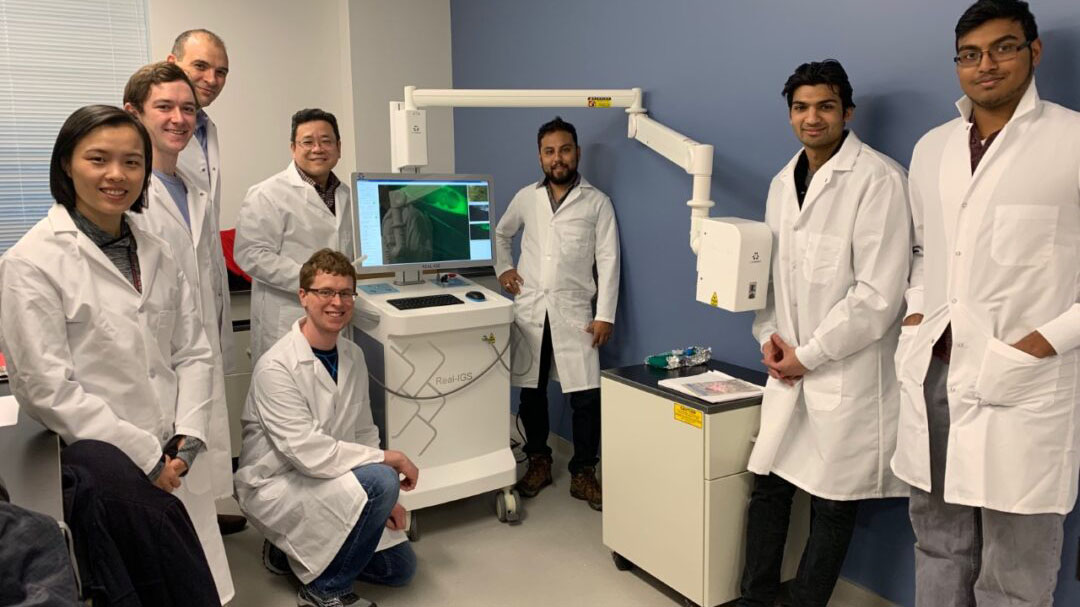 Illinois researchers with a prototype image-guided surgical system (standing third from left is Professor Viktor Gruev and fourth from left is Professor Shuming Nie).