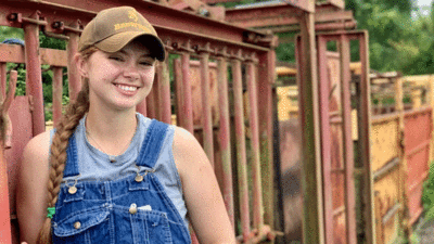 Sarah Graham in overalls on the U of I's South Farms