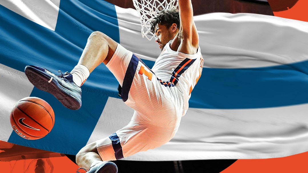 Illini graduate student Jacob Grandison hangs on the rim after a dunk
